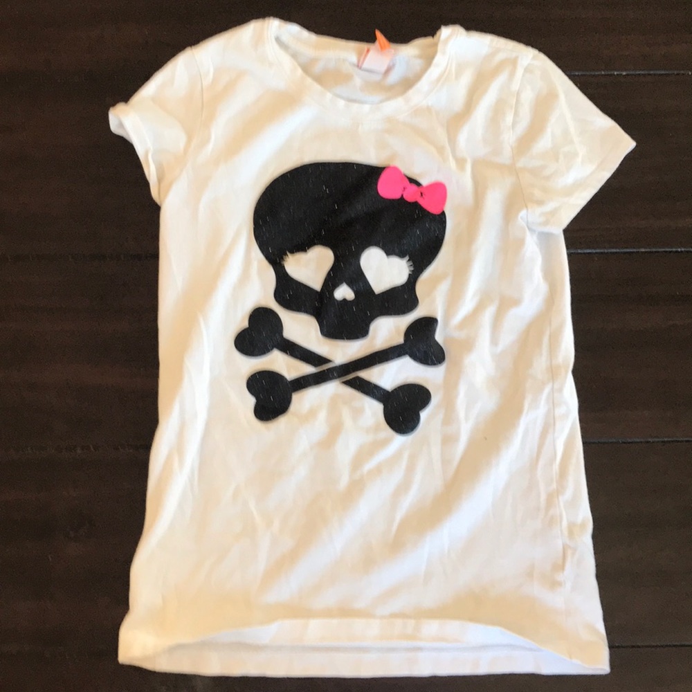 A shirt with a skeleton with a bow on it